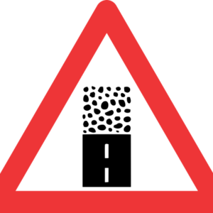 W325 - Gravel Road Begins Road Sign
